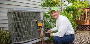 Technician performing maintenance on an outdoor cooling unit
